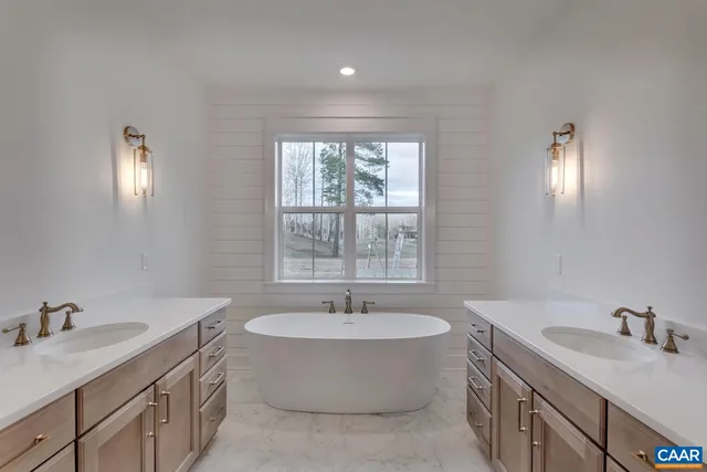 a bathroom with a sink double vanity and a tub