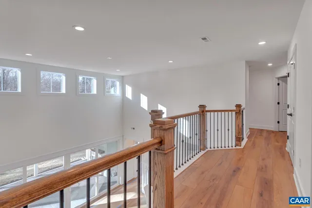 a view of a hallway with wooden floor