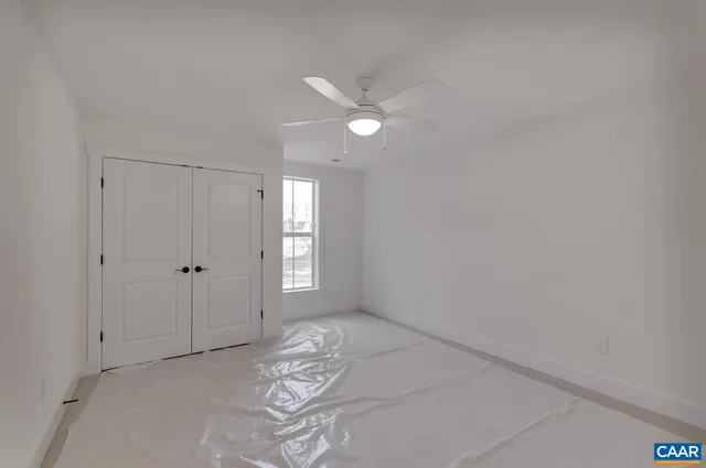 a view of a livingroom with an empty space and a ceiling fan