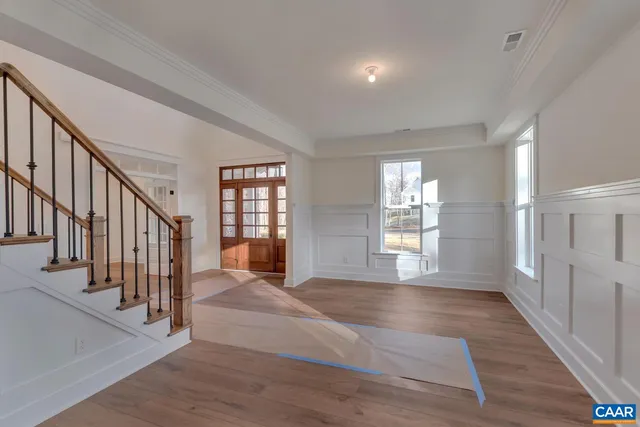 a view of an entryway with wooden floor