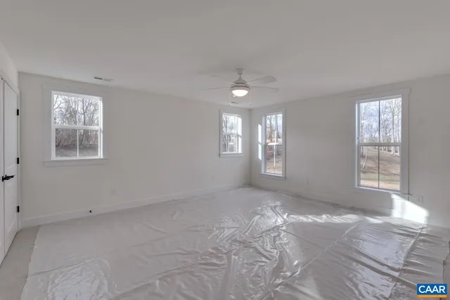 a view of an empty room with windows