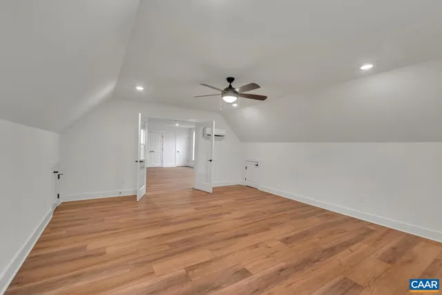 a view of an empty room with a ceiling fan
