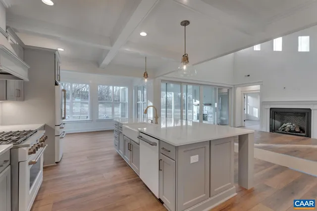 a kitchen with stainless steel appliances granite countertop a stove and a sink