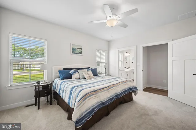 a spacious bedroom with a bed and a chandelier