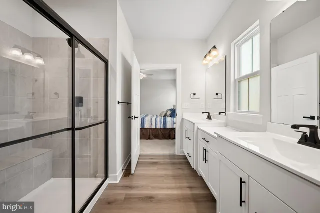 a spacious bathroom with a double vanity sink and mirror