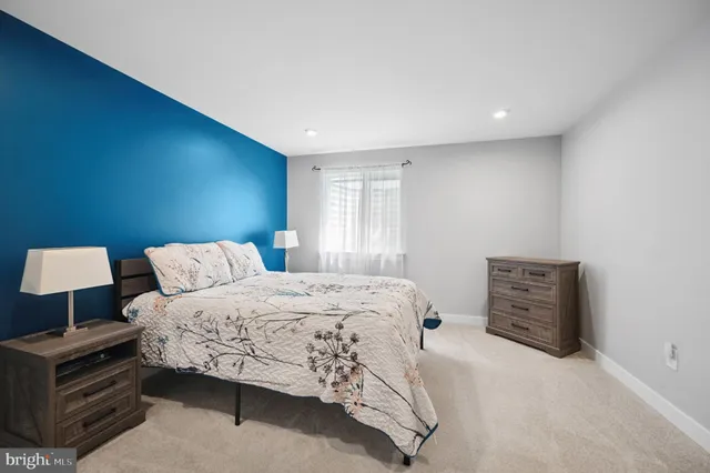 a bedroom with a bed and dresser