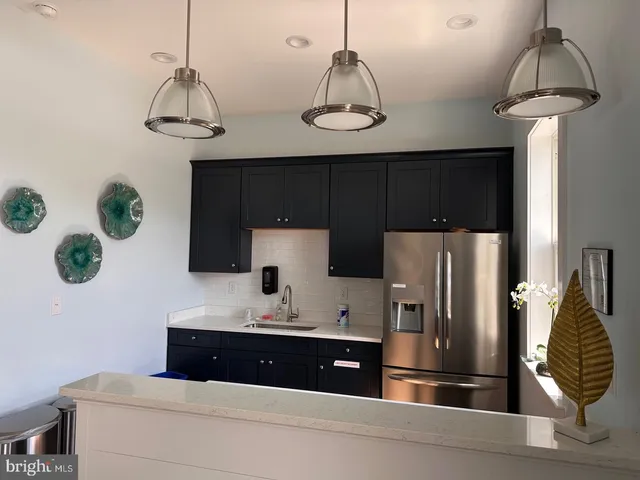a kitchen with stainless steel appliances a sink cabinets and refrigerator