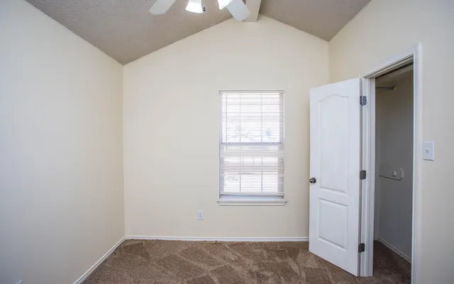 an empty room with windows and closet