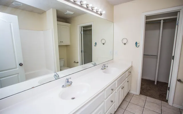 a bathroom with a double vanity sink and mirror