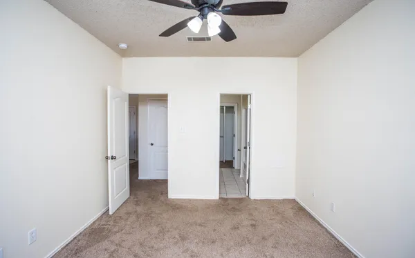 a view of a hallway with a chandelier fan
