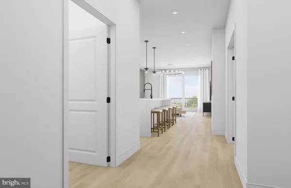 a kitchen with kitchen island a refrigerator a stove a oven and a sink with wooden floor