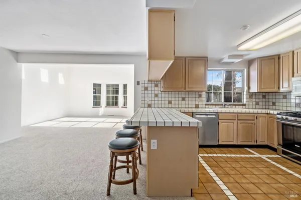 a kitchen that has a sink and a stove in it