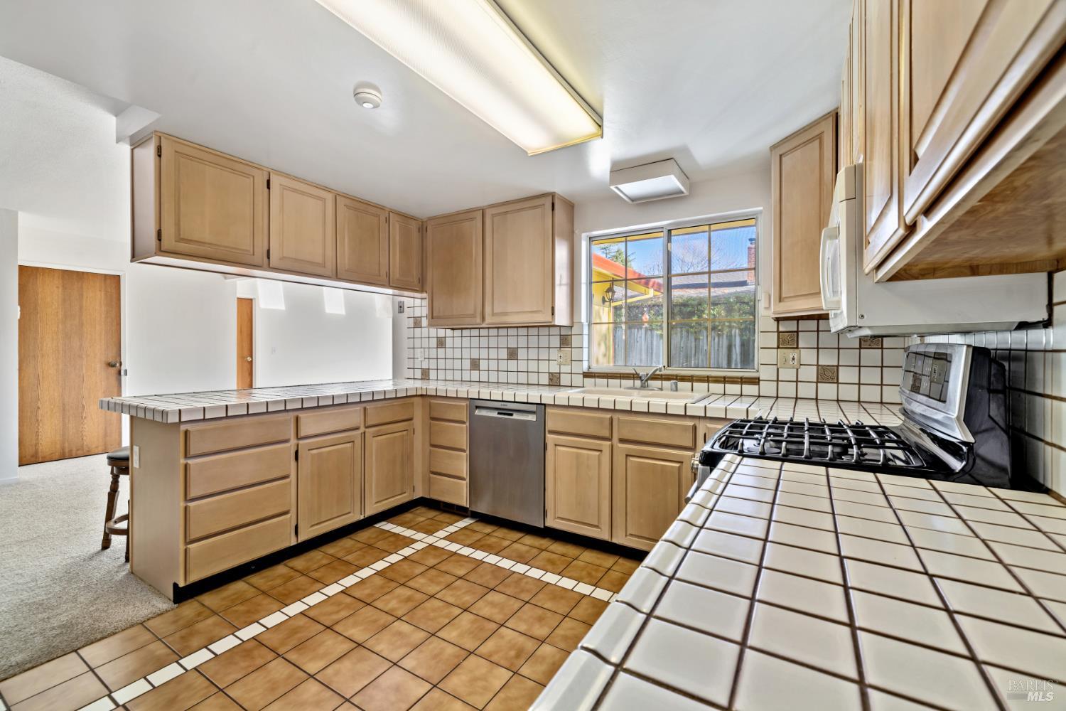 6 Oakhurst Place Santa Rosa, CA 95409 - Photo 14 of 42 a kitchen with a sink a stove cabinets and counter space