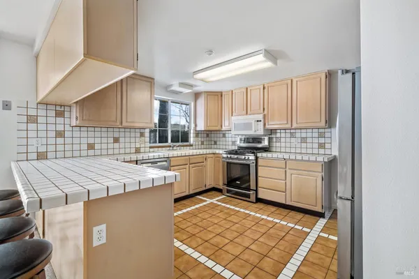 a kitchen that has a sink and a stove in it