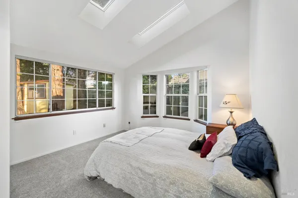 a bed sitting in a bedroom next to a window