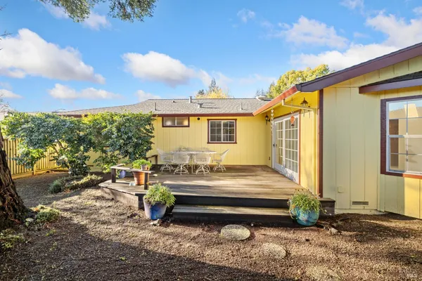 a backyard of a house with yard and outdoor seating