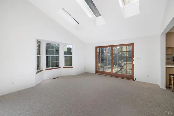 a view of an empty room with windows
