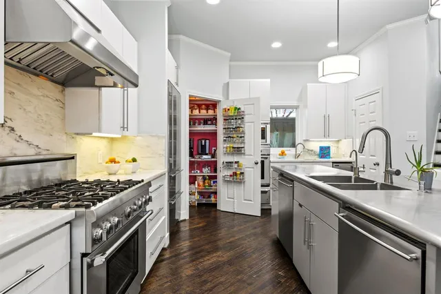 a kitchen with stainless steel appliances granite countertop a stove and a sink