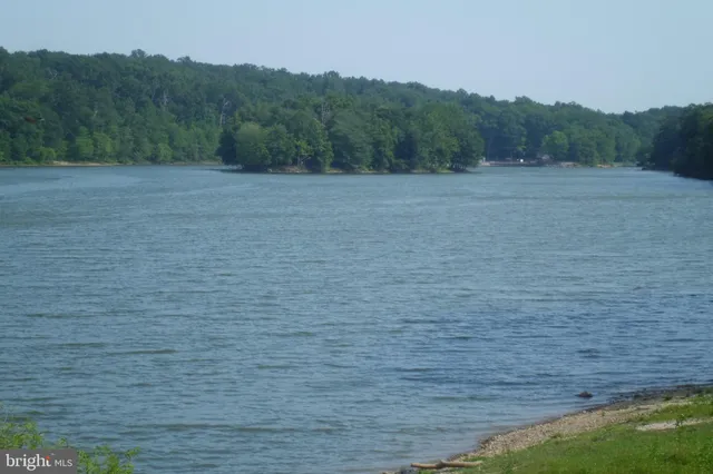a view of a lake and green valley