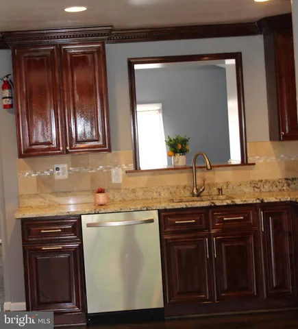 a kitchen with a refrigerator and a stove top oven