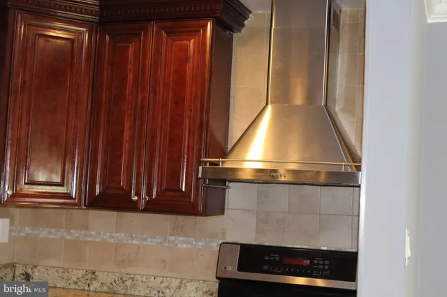 a kitchen with granite countertop stainless steel appliances and wooden cabinets