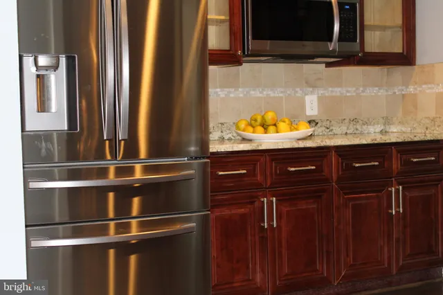 a kitchen with granite countertop a stove and a sink