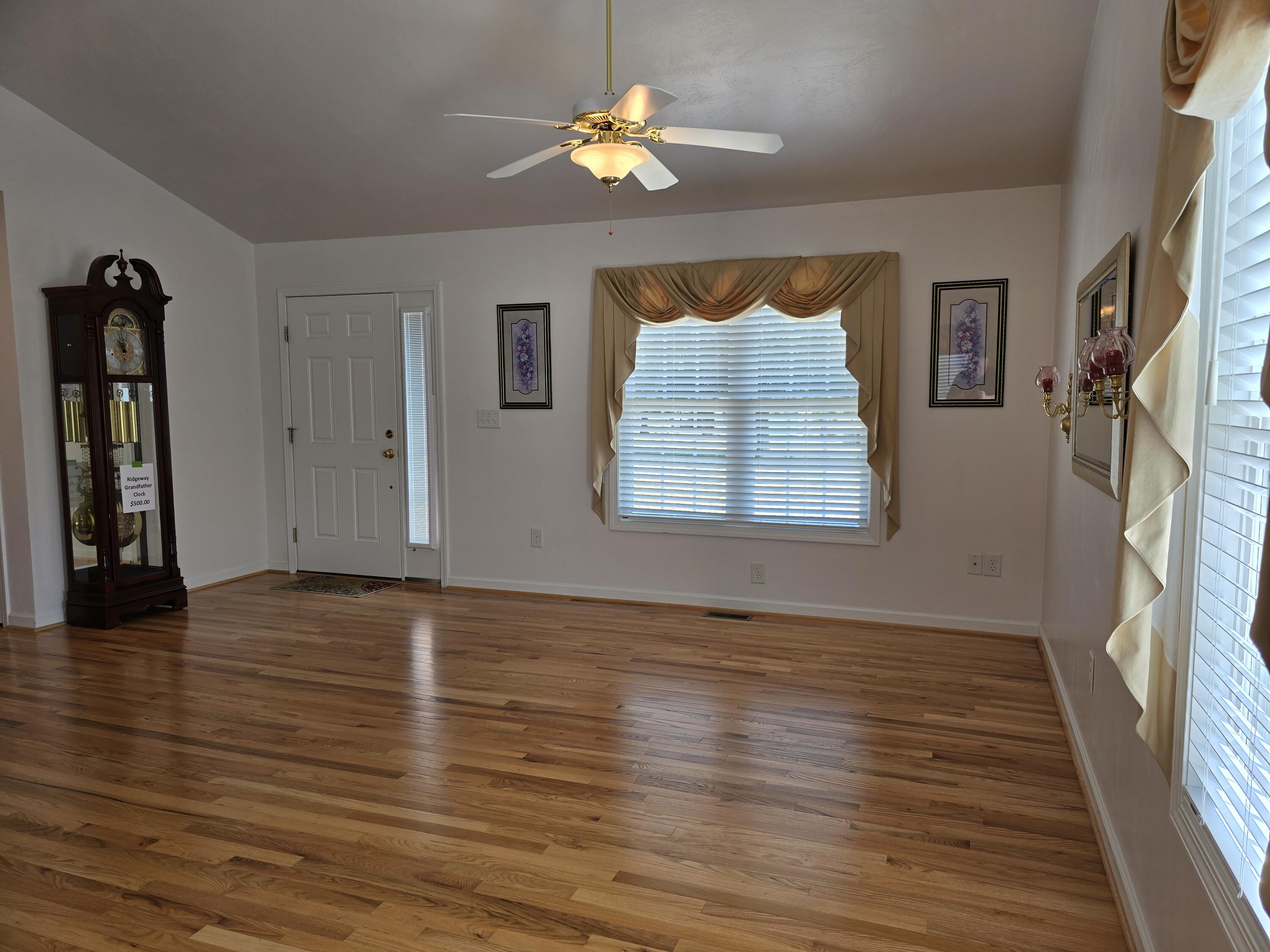 2341 Highland Road Roanoke, VA 24014 - Photo 6 of 30 a view of an empty room with wooden floor and a ceiling fan