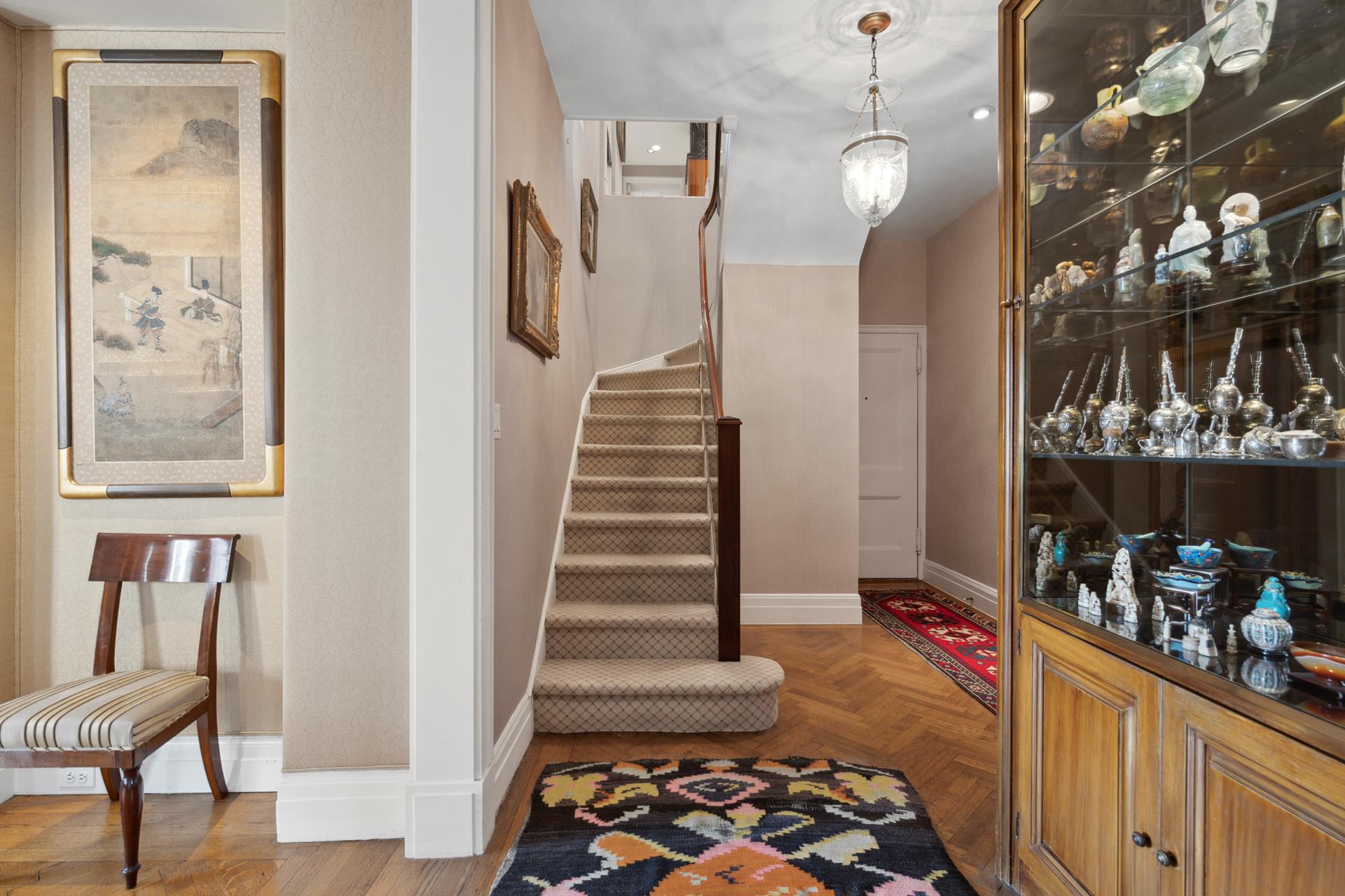 155 East 72nd Street, Unit 7C/8CD Manhattan, NY 10021 - Photo 8 of 17 a room with lots of white furniture and wooden floor