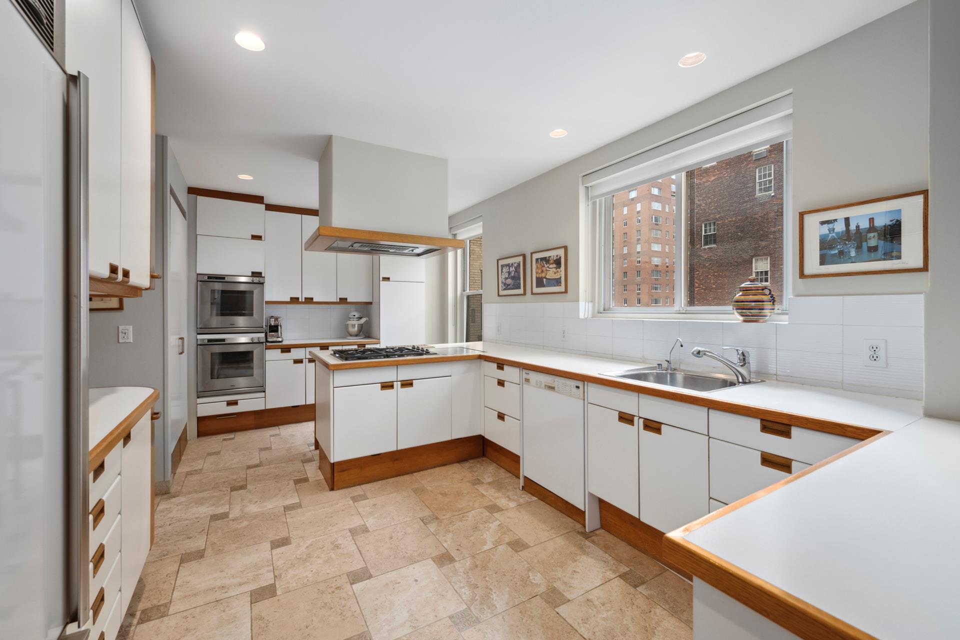 155 East 72nd Street, Unit 7C/8CD Manhattan, NY 10021 - Photo 9 of 17 a large kitchen with stainless steel appliances granite countertop a large counter top a stove a refrigerator and a sink