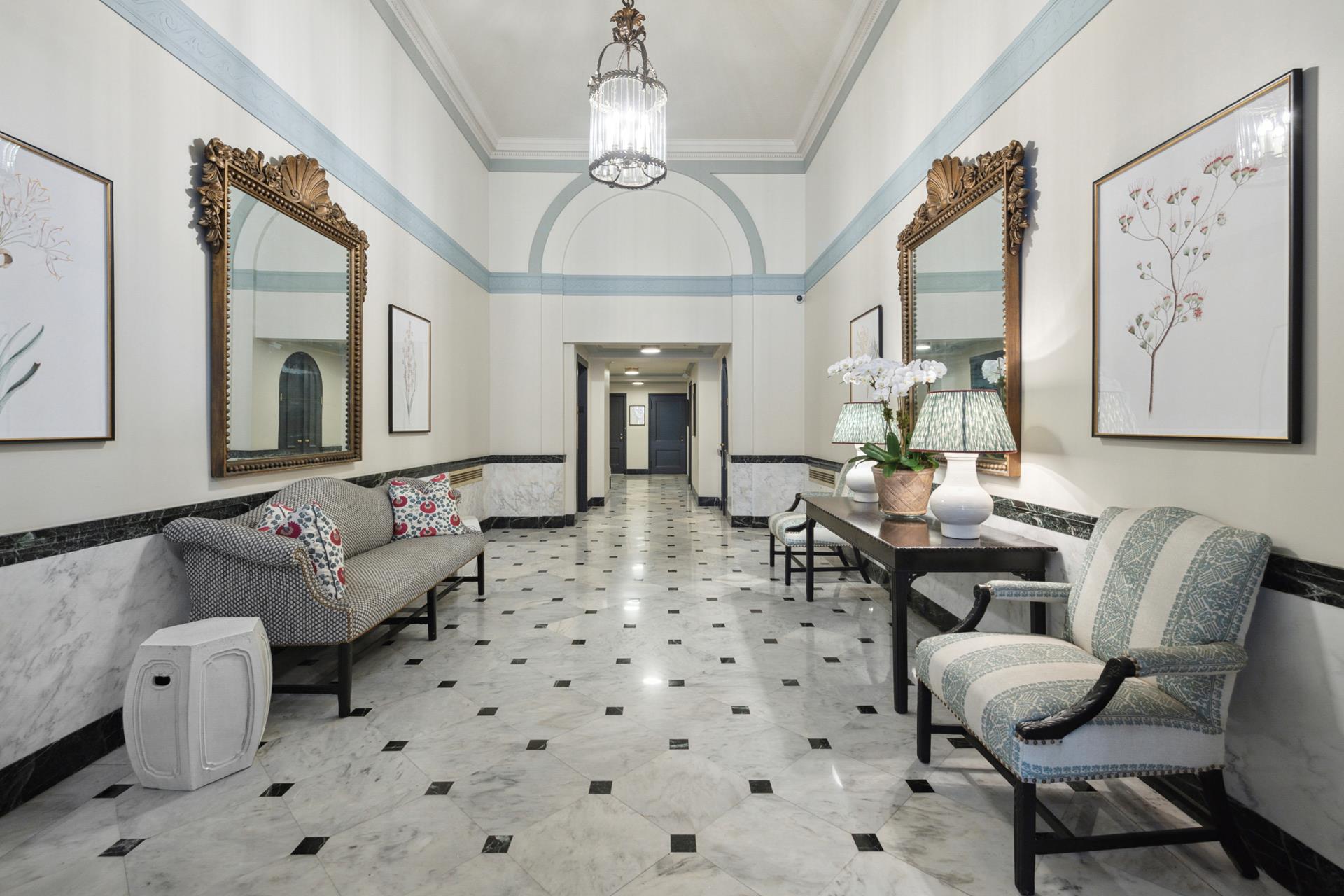 155 East 72nd Street, Unit 7C/8CD Manhattan, NY 10021 - Photo 13 of 17 a living room with furniture and a chandelier