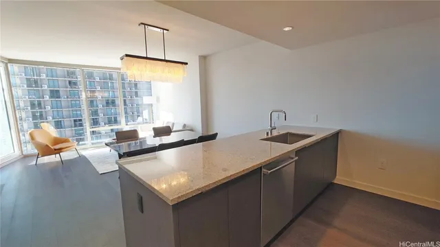 a kitchen with a sink a counter and chairs