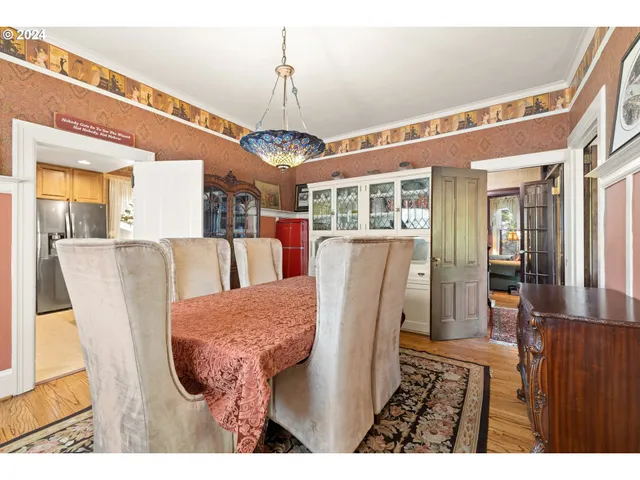 a view of a dining room with furniture wooden floor and chandelier