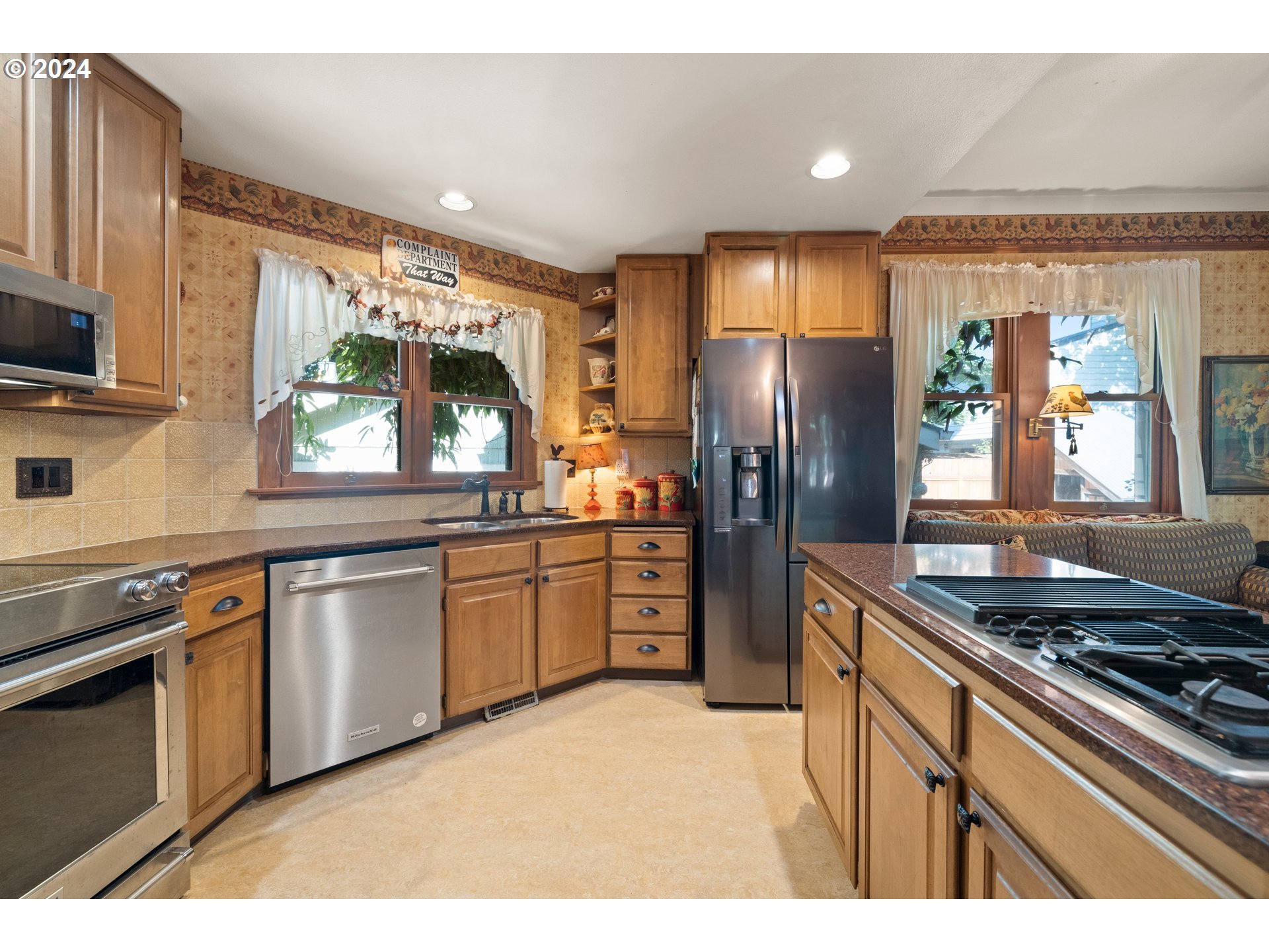 1927 Northeast 16th Avenue Portland, OR 97212 - Photo 22 of 43 a kitchen with stainless steel appliances granite countertop a stove a sink and a refrigerator