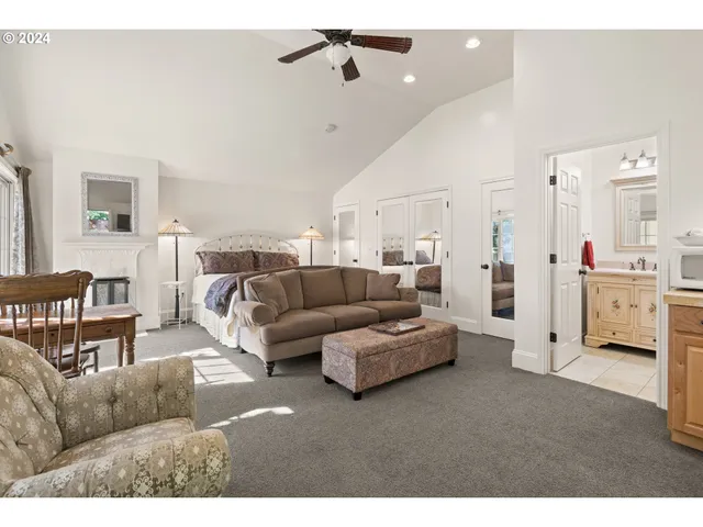 a living room with furniture and a ceiling fan