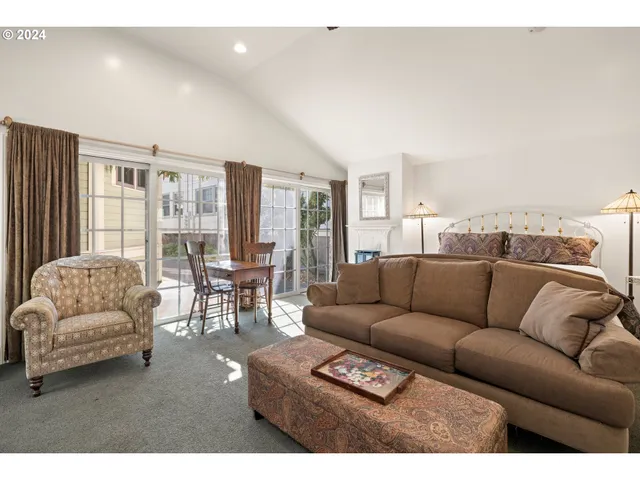 a living room with furniture and large windows