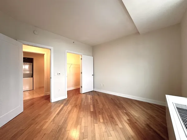 a view of an empty room and wooden floor