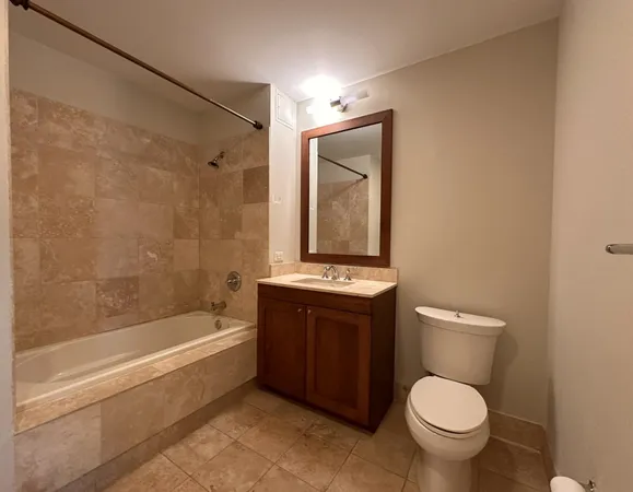 a bathroom with a granite countertop toilet a sink and bathtub