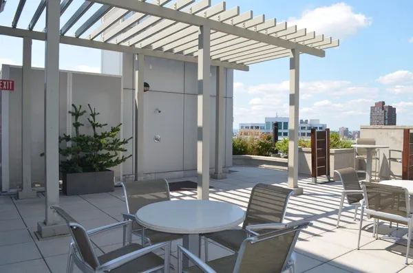 a view of a patio with a dining table and chairs