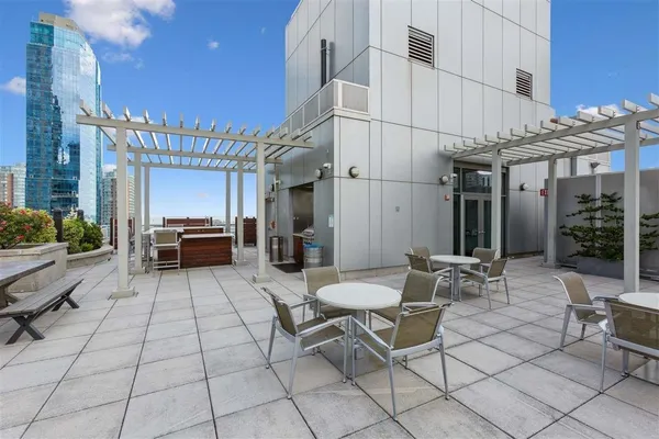 a building outdoor space with patio furniture and potted plants