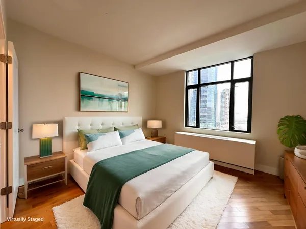 a bedroom with a large bed and a window