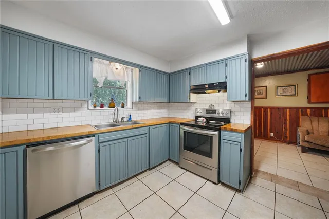 a kitchen with stainless steel appliances granite countertop a sink and cabinets