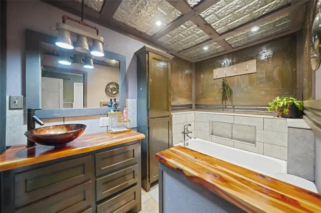 a room with sink and mirror