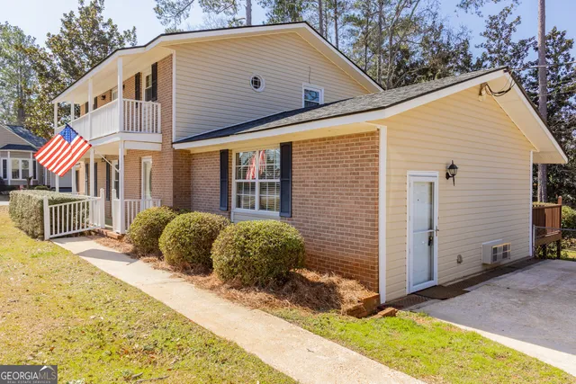 a house that has a tree in front of it