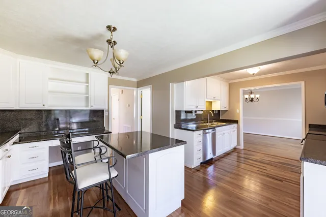a kitchen with stainless steel appliances a white cabinets and a counter top space