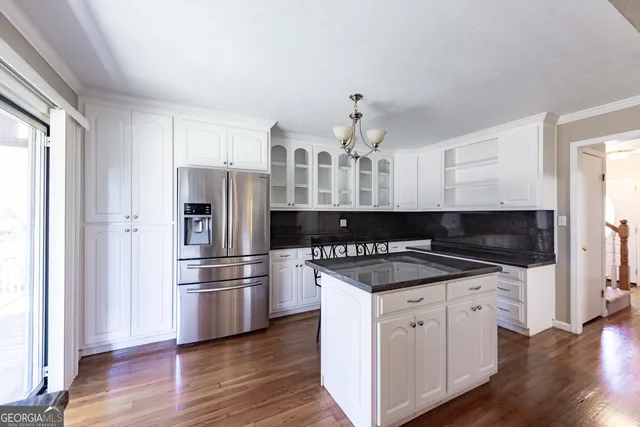 a large kitchen with stainless steel appliances granite countertop a stove a sink dishwasher and a microwave