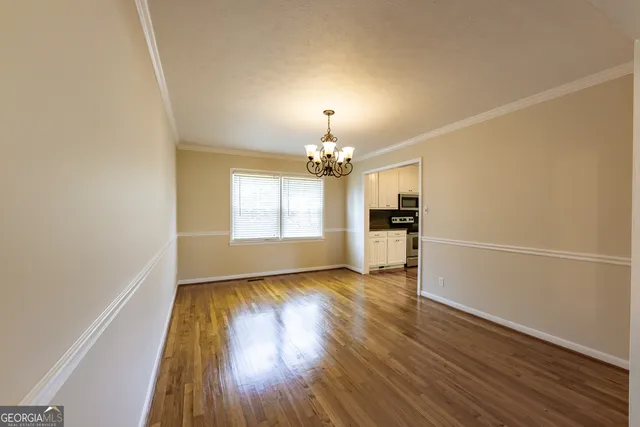 a view of a dining room with furniture and a chandelier