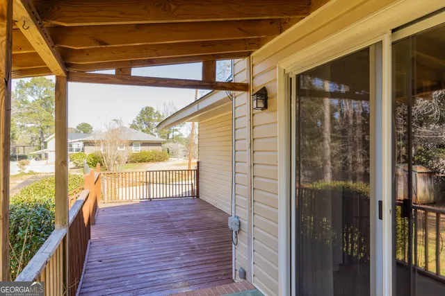 a view of a balcony with wooden floor and fence