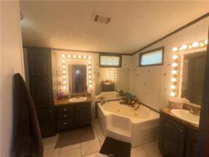 309 Limestone County Road Jewett, TX 75846 - Photo 8 of 15 a bathroom with a sink and a mirror