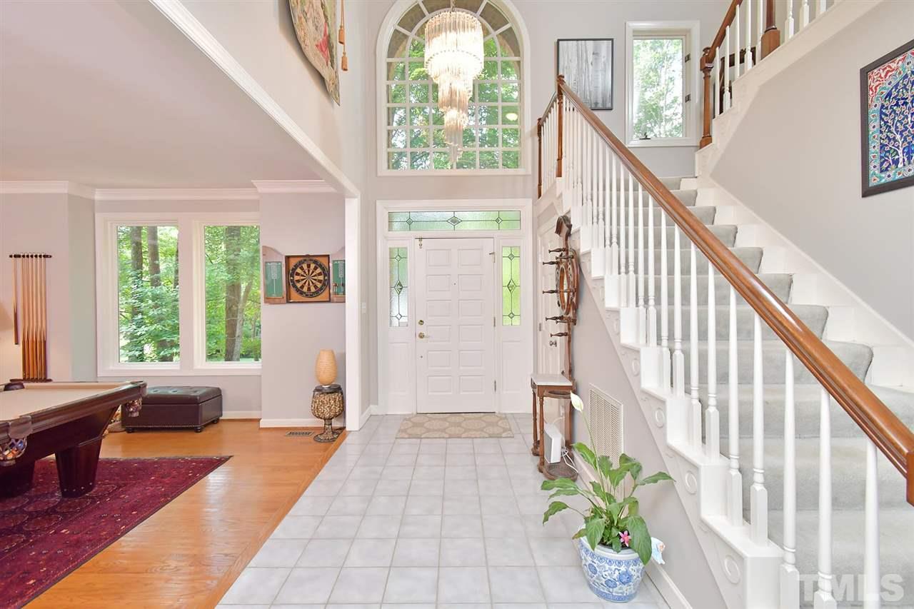 5220 Lenoraway Drive Raleigh, NC 27613 - Photo 2 of 30 2 story Foyer opens to Game Room with Custom designed Bar, Dining Room, and hallway to First Floor Master Bedroom.