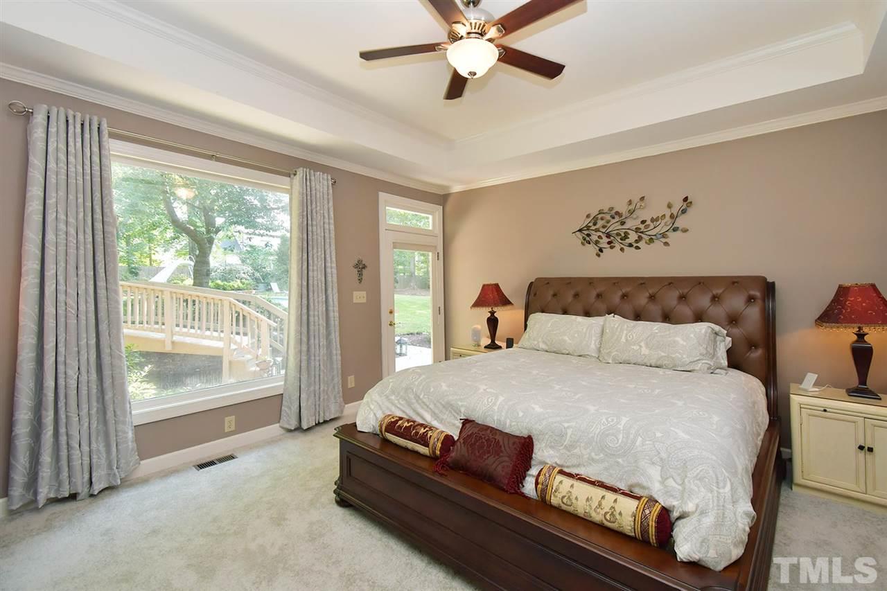 5220 Lenoraway Drive Raleigh, NC 27613 - Photo 12 of 30 Master Bedroom with tray ceiling and large window for gorgeous natural light, view of backyard oasis.